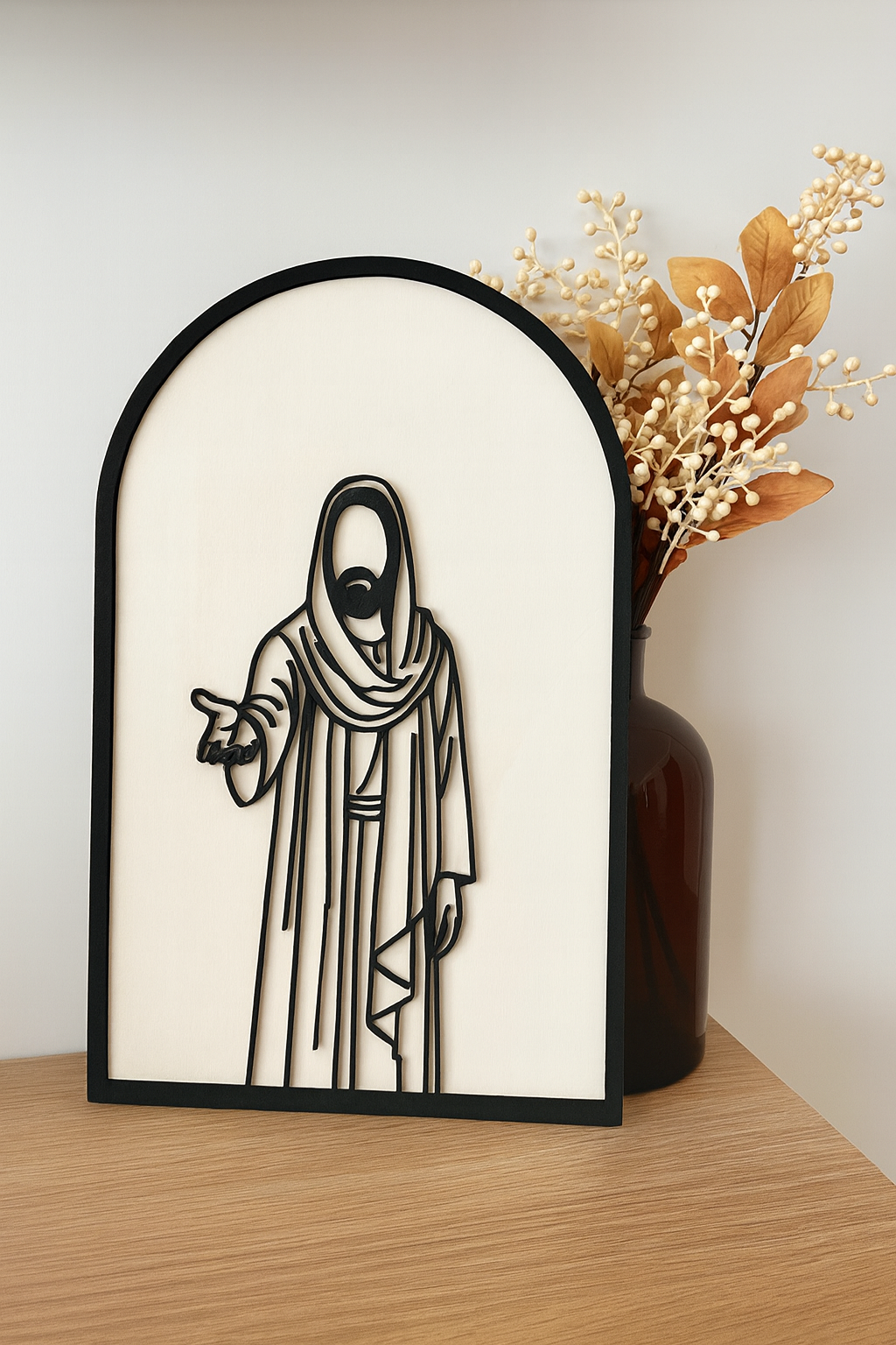 Medium size He Is Risen basswood cutout with layered ‘Jesus’ text displayed against a neutral wall